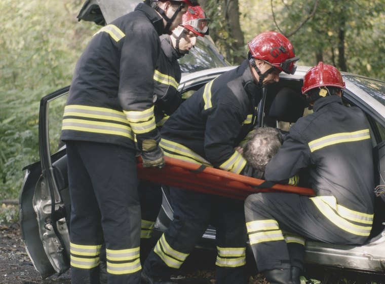 Emergency crews extricating a crash victim from a vehicle