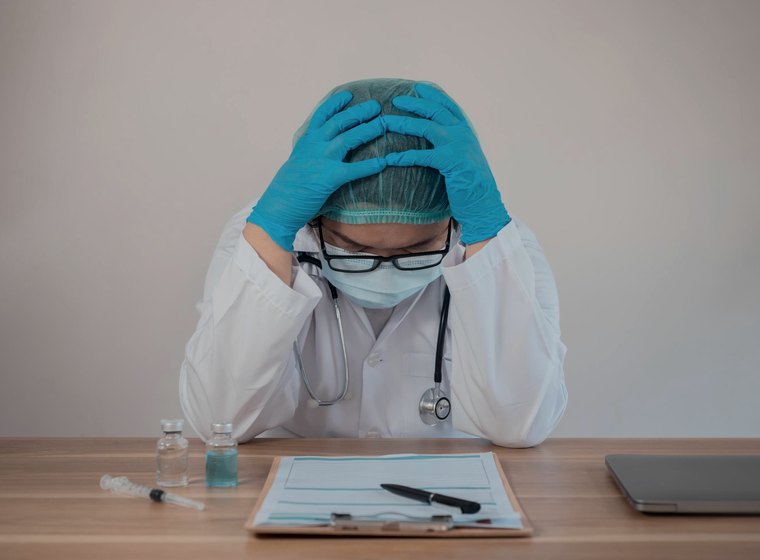 Physician at a desk after a difficult outcome